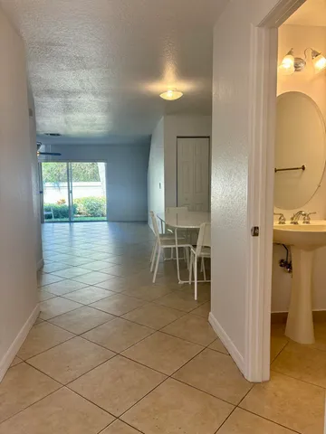 a dining room that has a rug and a chair in it