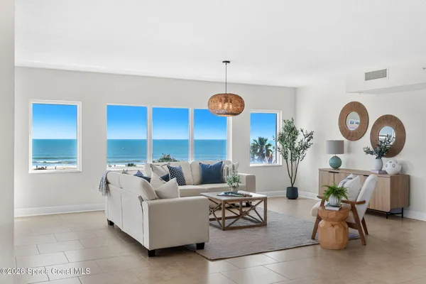 a living room with furniture and a clock