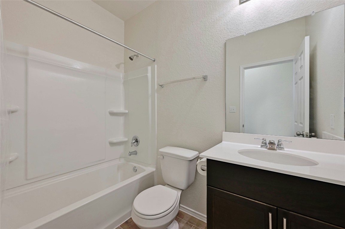 529 Tree Nut Loop Buda, TX 78610 - Photo 20 of 37 a bathroom with a sink a toilet and shower