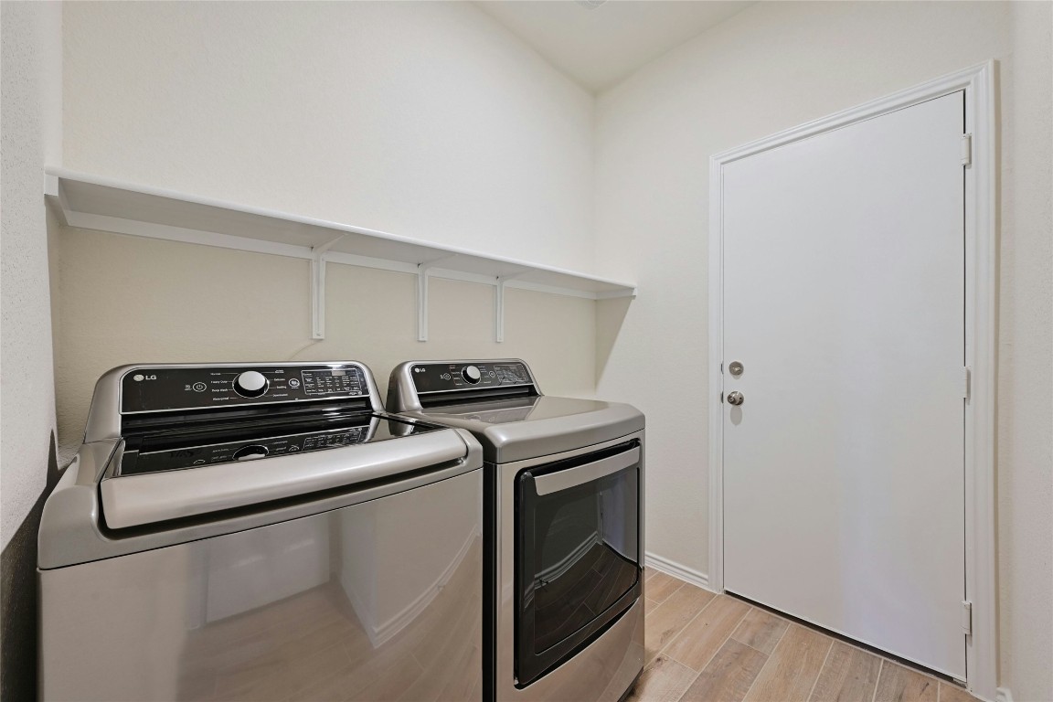 529 Tree Nut Loop Buda, TX 78610 - Photo 22 of 37 a view of storage and utility room with washer and dryer