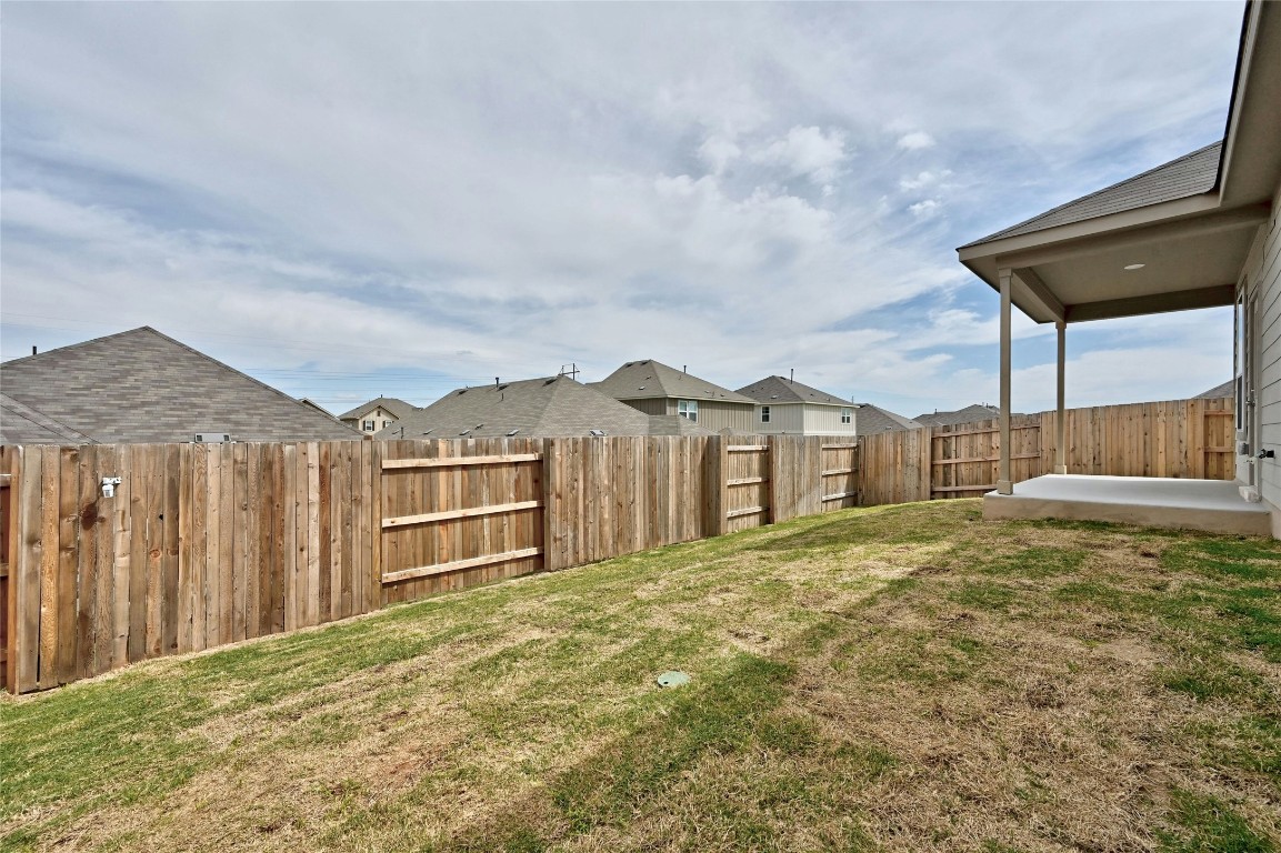 529 Tree Nut Loop Buda, TX 78610 - Photo 24 of 37 a view of a house with a backyard and wooden fence