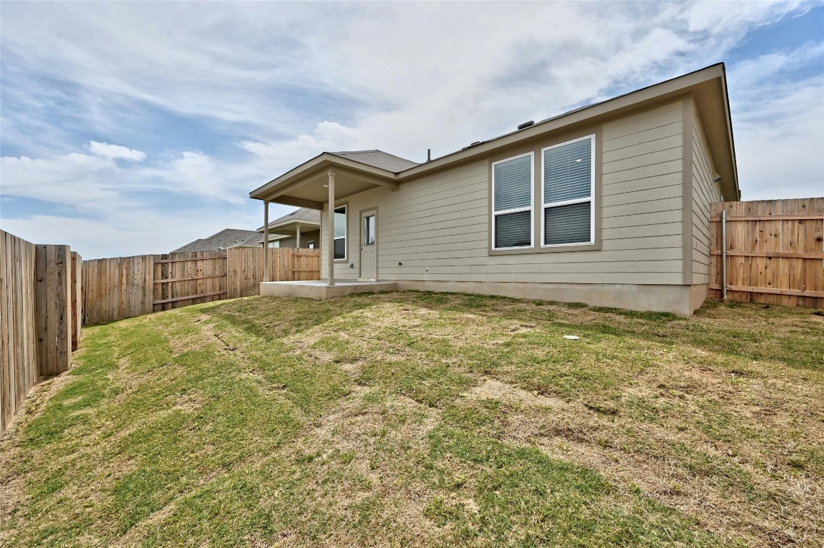 529 Tree Nut Loop Buda, TX 78610 - Photo 25 of 37 a house view with wooden fence