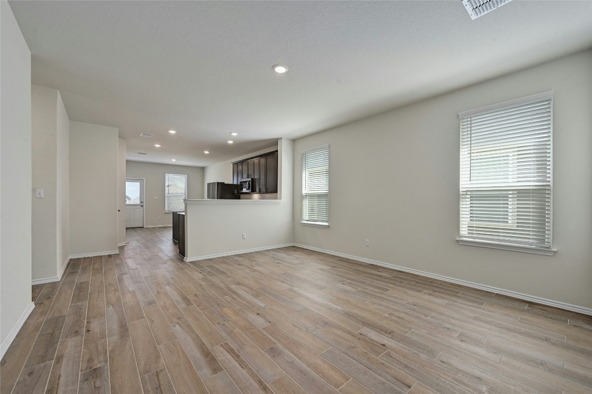 529 Tree Nut Loop Buda, TX 78610 - Photo 3 of 37 a view of a livingroom with wooden floor
