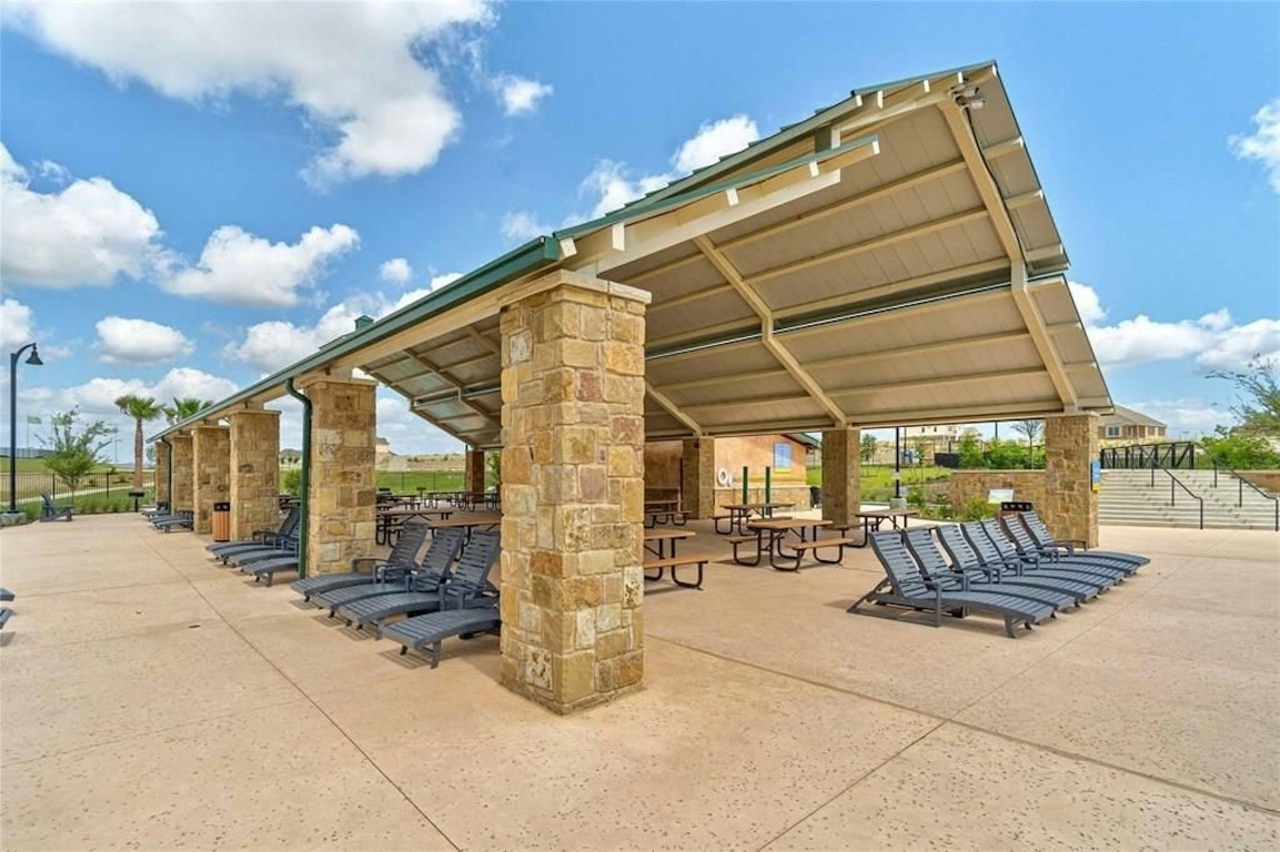 529 Tree Nut Loop Buda, TX 78610 - Photo 36 of 37 a building outdoor space with patio furniture and potted plants