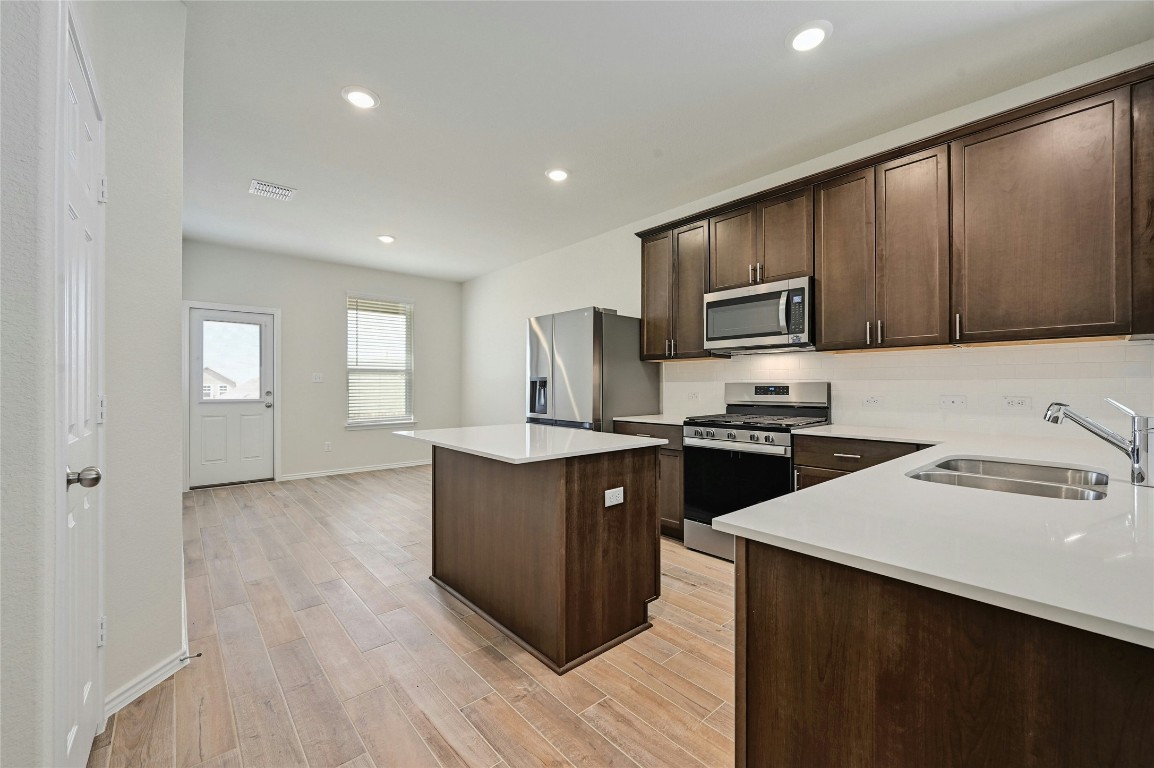 529 Tree Nut Loop Buda, TX 78610 - Photo 9 of 37 a kitchen with a sink cabinets and appliances