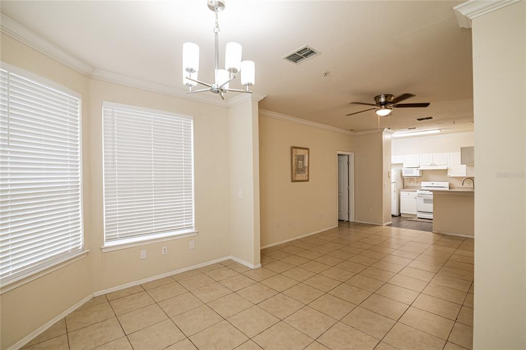 3391 South Kirkman Road, Unit 1216 Orlando, FL 32811 - Photo 14 of 33 a view of a livingroom with a chandelier furniture and windows