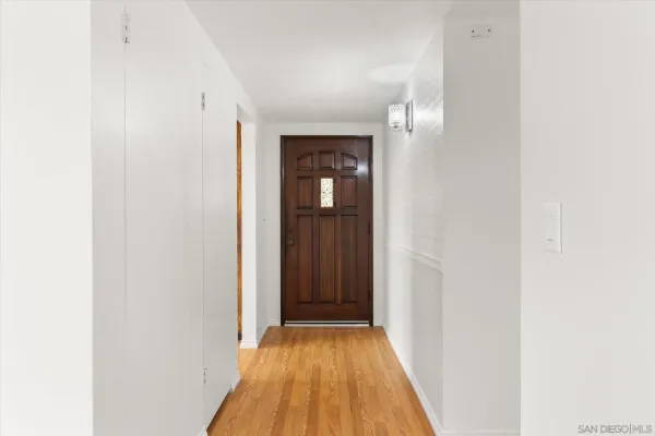 a view of a hallway with wooden floor
