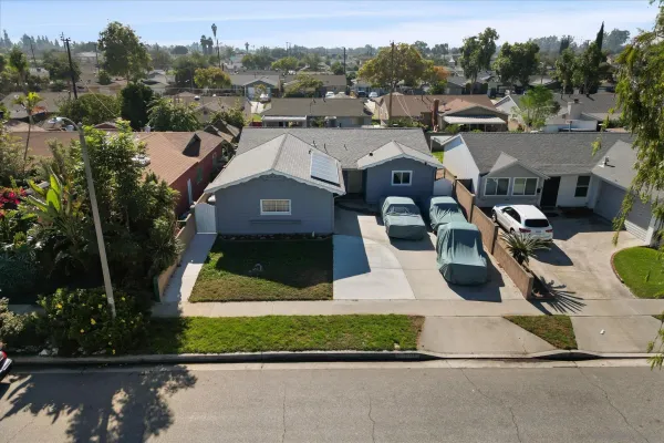 an aerial view of a house with a yard and lake view
