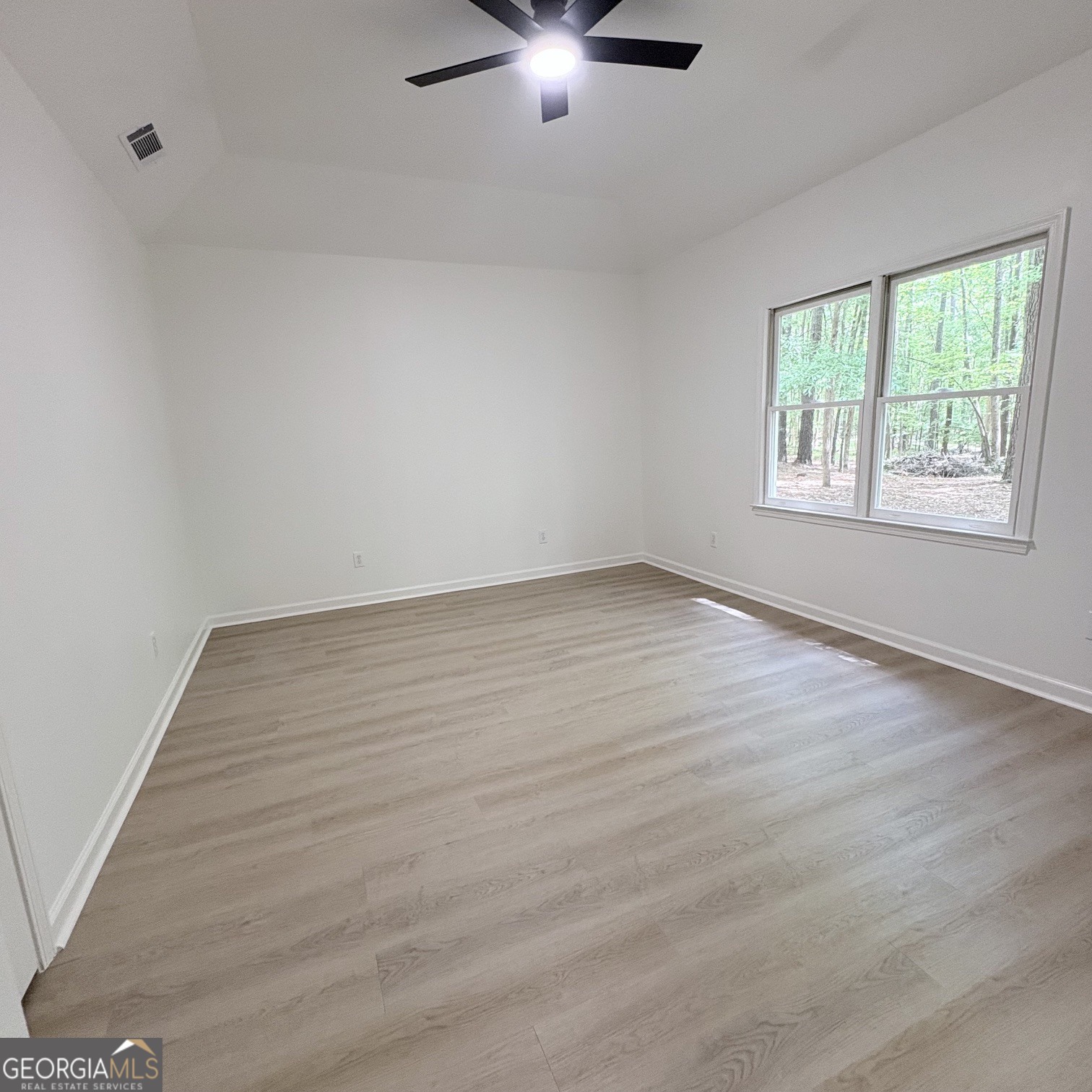 190 Rockington Drive Tyrone, GA 30290 - Photo 38 of 54 an empty room with wooden floor fan and windows