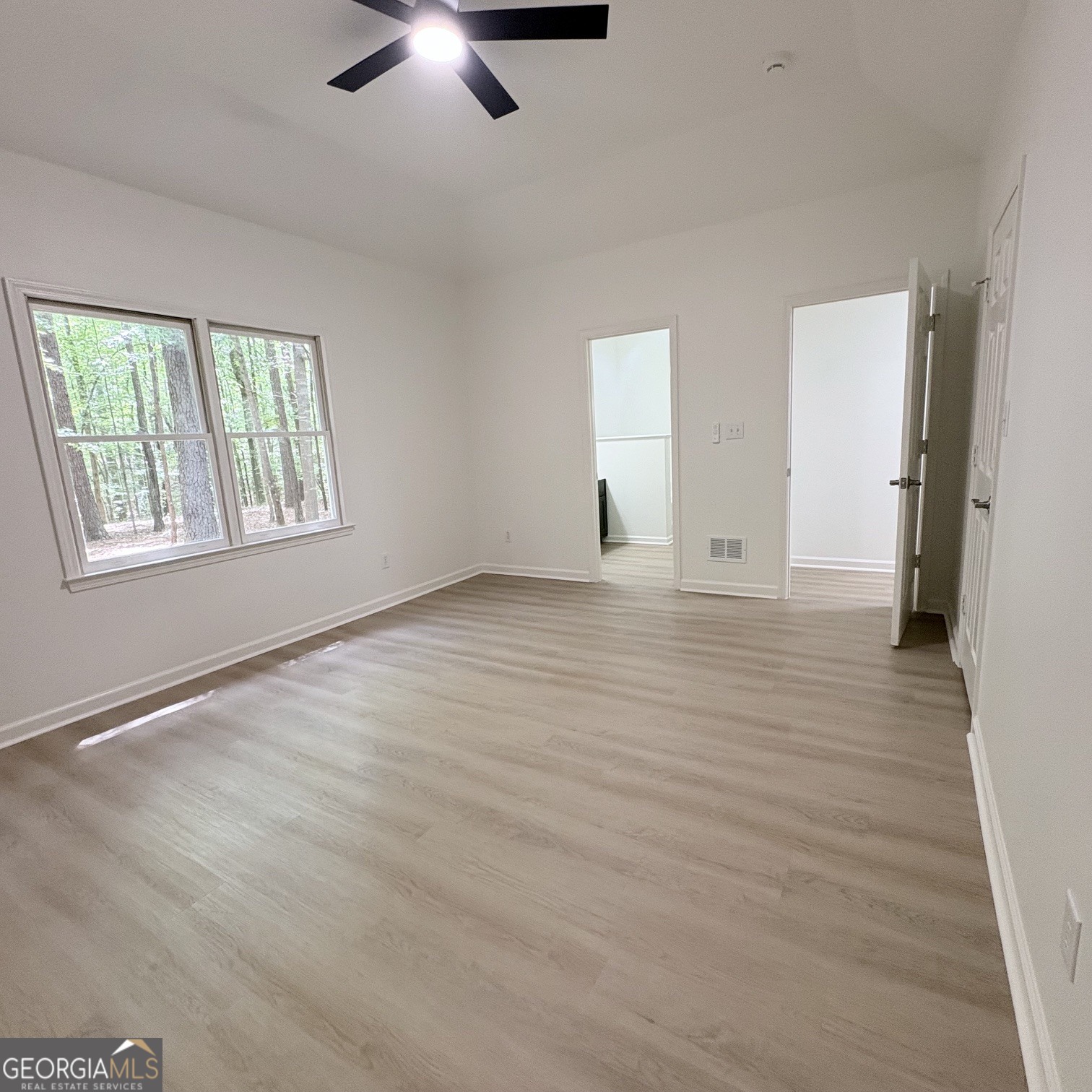 190 Rockington Drive Tyrone, GA 30290 - Photo 39 of 54 a view of an empty room with a window and wooden floor