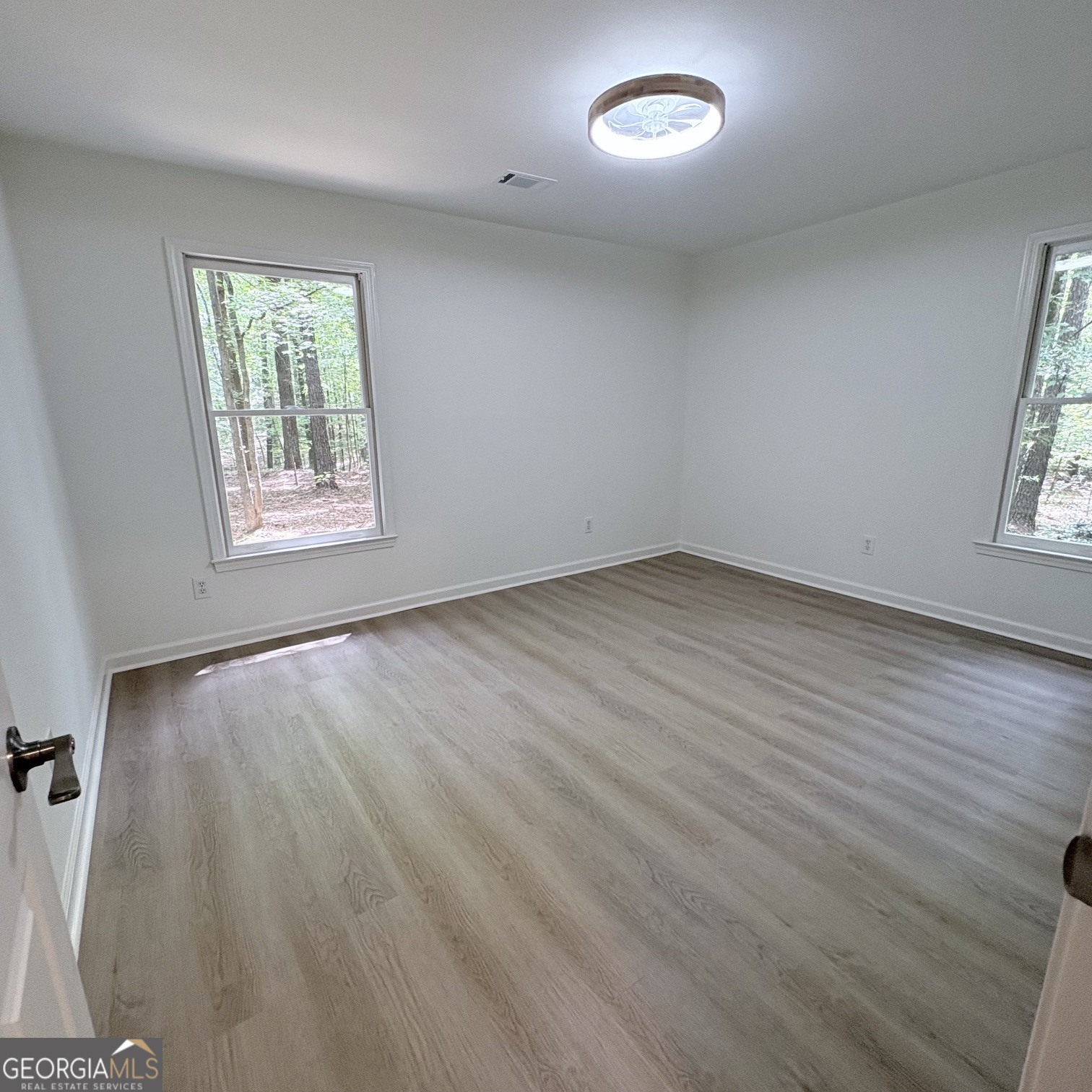 190 Rockington Drive Tyrone, GA 30290 - Photo 46 of 54 an empty room with wooden floor and windows