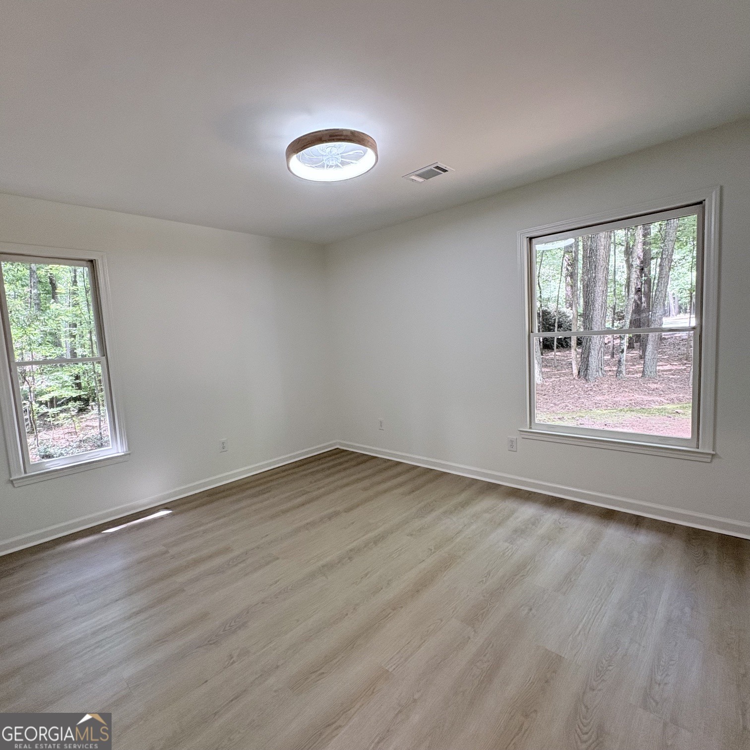 190 Rockington Drive Tyrone, GA 30290 - Photo 47 of 54 an empty room with wooden floor and windows