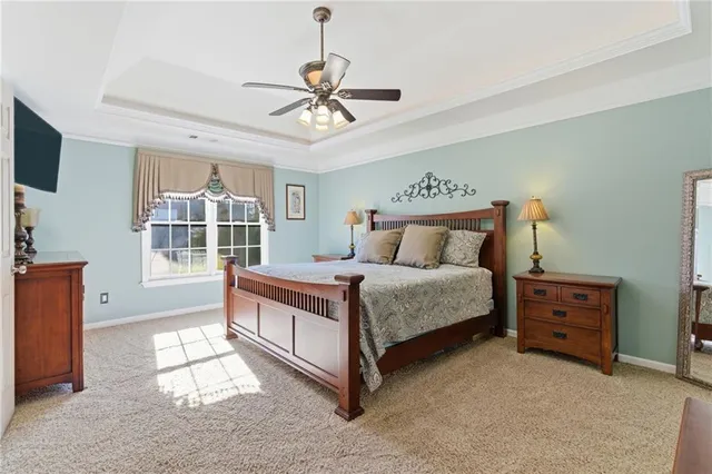 a bedroom with a large bed and a chandelier