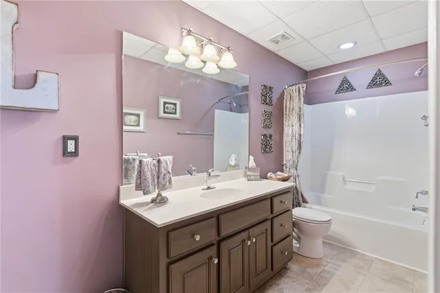 a bathroom with a sink vanity tub toilet and a mirror