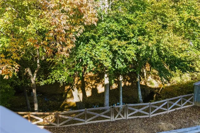 a backyard of a house with lots of plants and trees