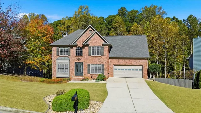 a view of a house with swimming pool next to a yard