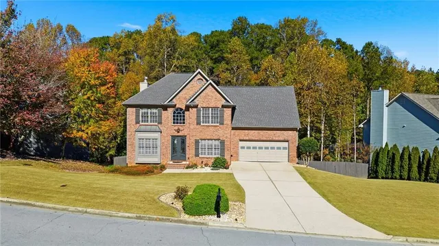 a front view of a house with a yard