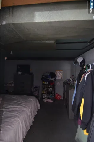 a bed sitting in a bedroom next to a lamp