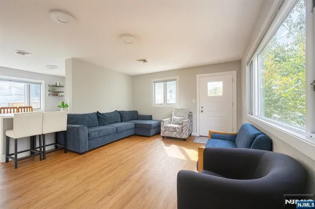 a living room with furniture and a large window