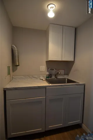 a room with a sink cabinets and utility
