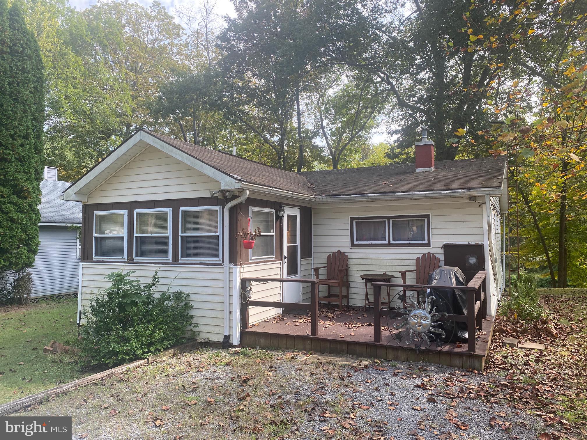100 Bubbling Spring Road Yellow Spring, WV 26865 - Photo 2 of 26 a view of a house with a yard and sitting area