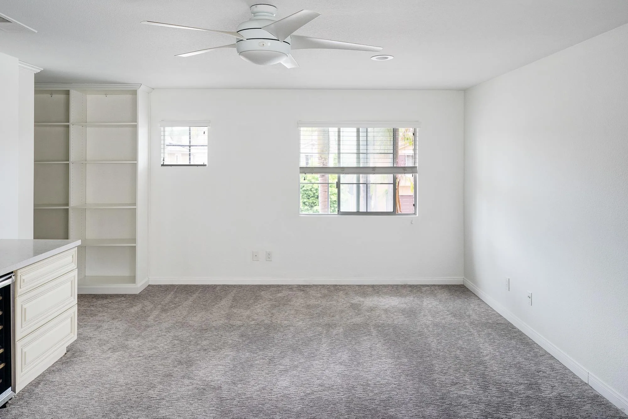 4318 Meadow Spring Way Oceanside, CA 92057 - Photo 21 of 50 an empty room with chandelier fan and windows