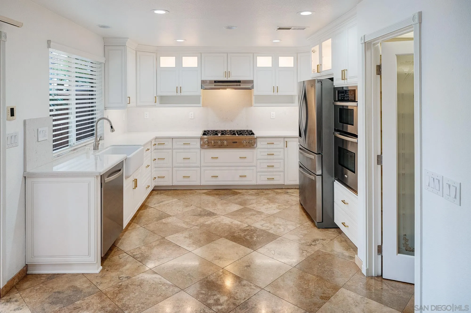 4318 Meadow Spring Way Oceanside, CA 92057 - Photo 3 of 50 a kitchen with stainless steel appliances kitchen island granite countertop a refrigerator and a stove