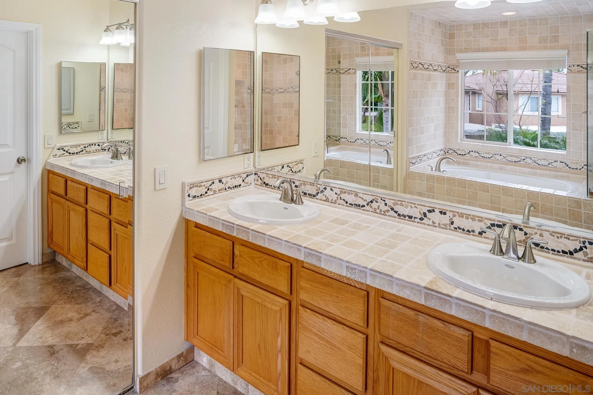 4318 Meadow Spring Way Oceanside, CA 92057 - Photo 31 of 50 a bathroom with double vanity sink and a mirror