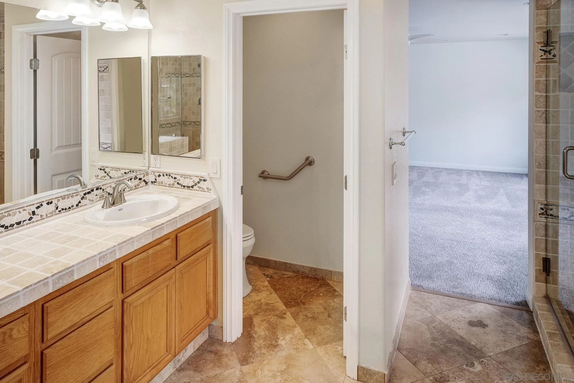 4318 Meadow Spring Way Oceanside, CA 92057 - Photo 33 of 50 a bathroom with a sink and a mirror