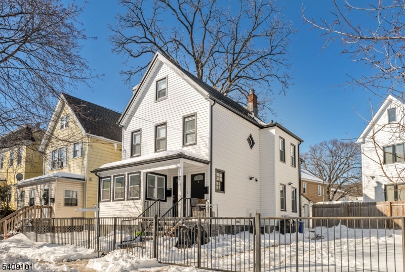 a view of a white house with a yard