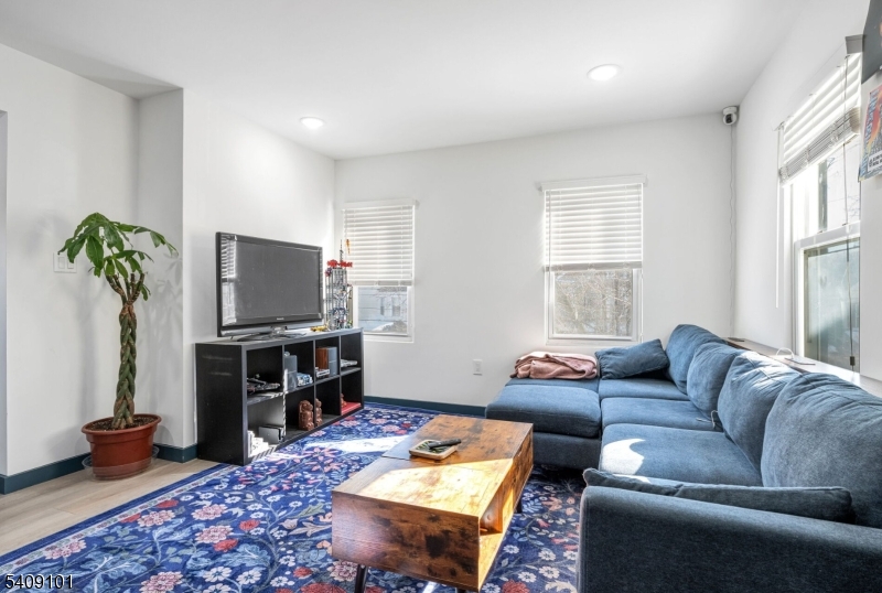 17 Mission Street Montclair, NJ 07042 - Photo 17 of 35 a living room with furniture a window and a flat screen tv