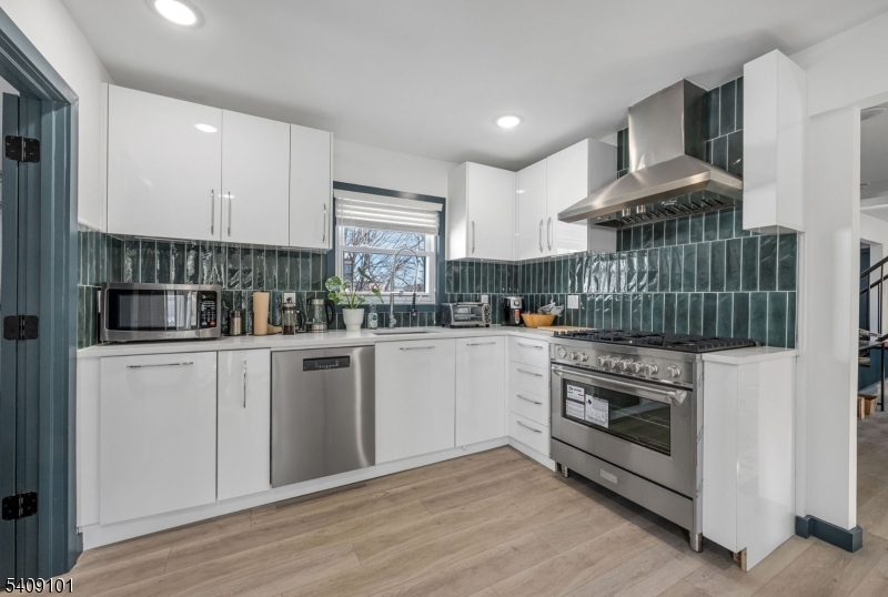 17 Mission Street Montclair, NJ 07042 - Photo 20 of 35 a kitchen with stainless steel appliances granite countertop a stove a sink and a refrigerator