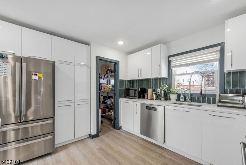 17 Mission Street Montclair, NJ 07042 - Photo 21 of 35 a kitchen with stainless steel appliances a refrigerator and a stove top oven