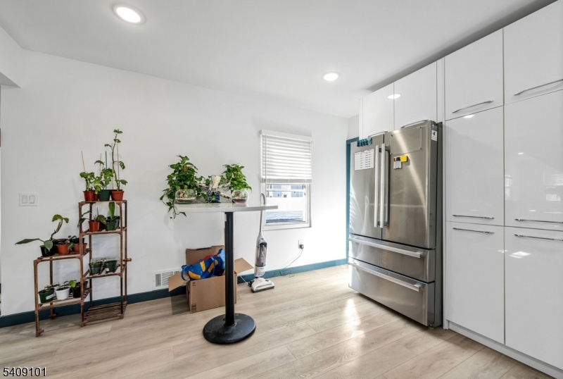 17 Mission Street Montclair, NJ 07042 - Photo 22 of 35 a kitchen with stainless steel appliances a refrigerator and wooden floor