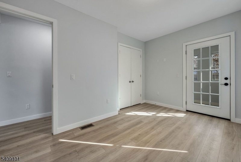 17 Mission Street Montclair, NJ 07042 - Photo 7 of 35 an empty room with wooden floor and white walls