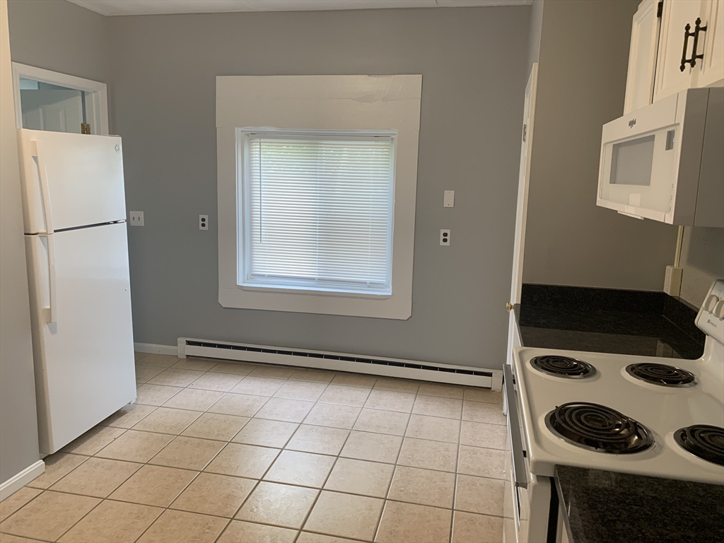 28-30 Alpine Place Franklin, MA 02038 - Photo 14 of 21 a kitchen with a stove and a refrigerator