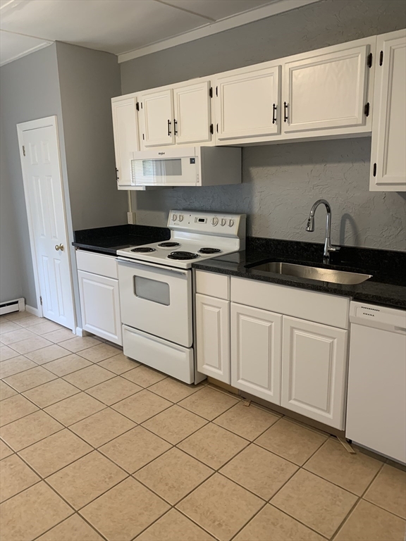 28-30 Alpine Place Franklin, MA 02038 - Photo 15 of 21 a kitchen with granite countertop white cabinets and white appliances