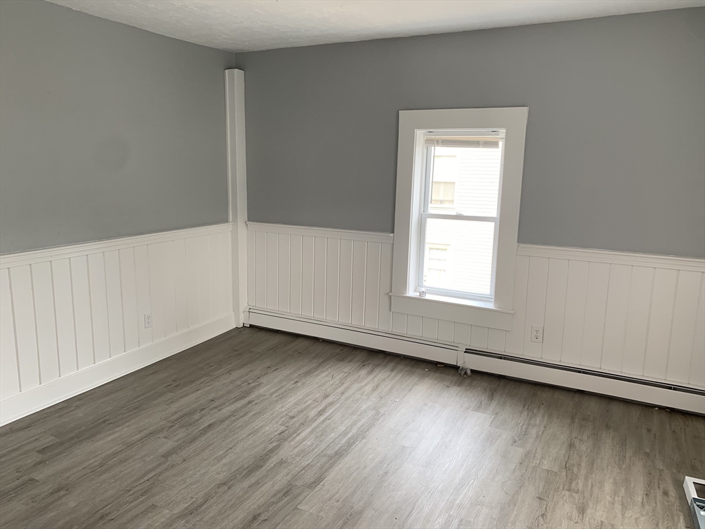 28-30 Alpine Place Franklin, MA 02038 - Photo 16 of 21 an empty room with wooden floor and windows