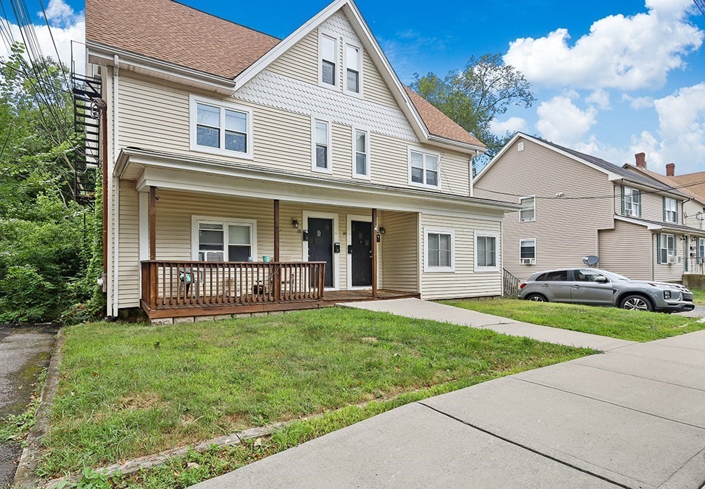 28-30 Alpine Place Franklin, MA 02038 - Photo 3 of 21 a front view of a house with a yard and porch
