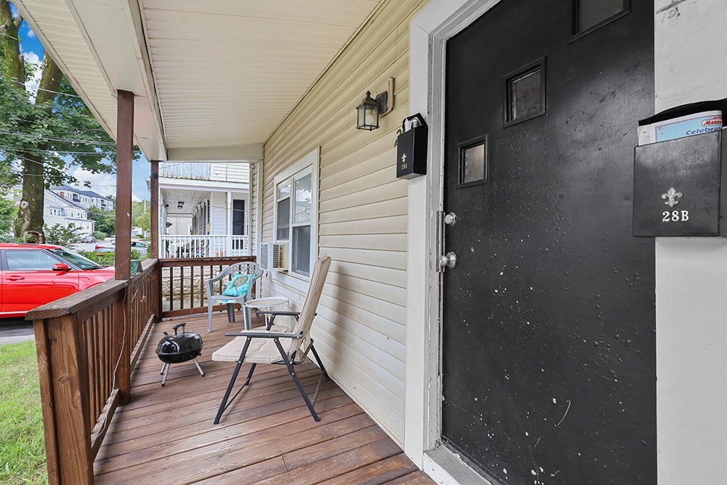28-30 Alpine Place Franklin, MA 02038 - Photo 8 of 21 a view of a balcony with wooden floor and outdoor seating