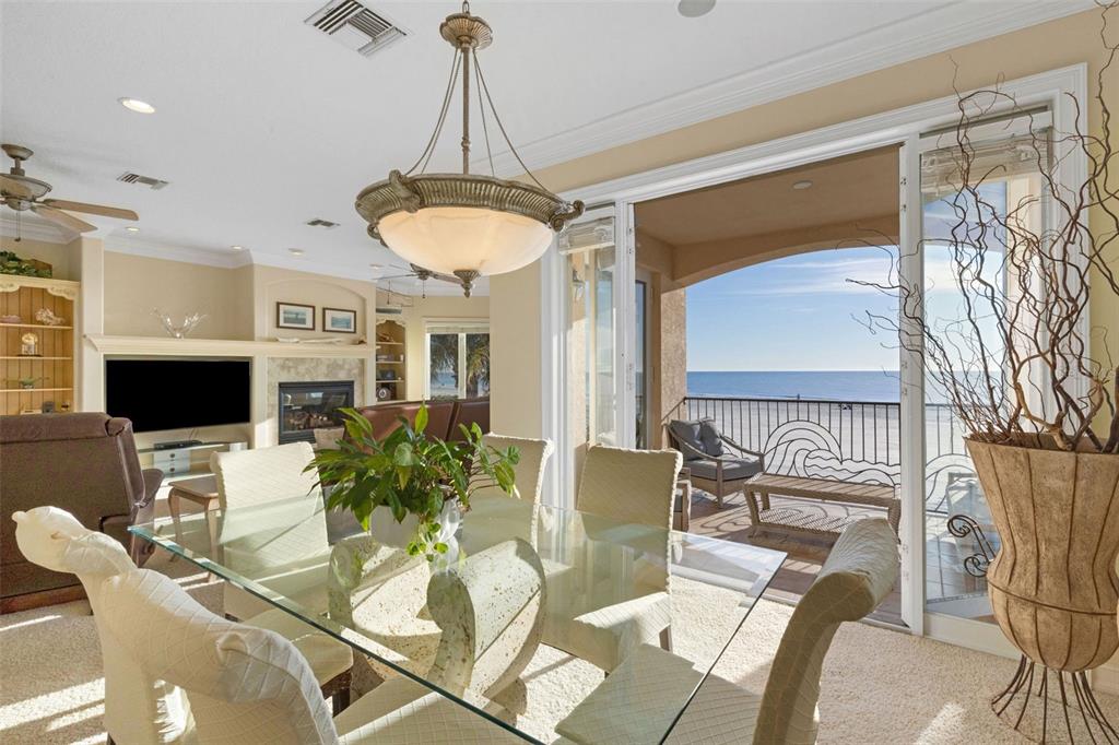 13423 Gulf Lane Madeira Beach, FL 33708 - Photo 11 of 71 a dining room with furniture a chandelier and wooden floor