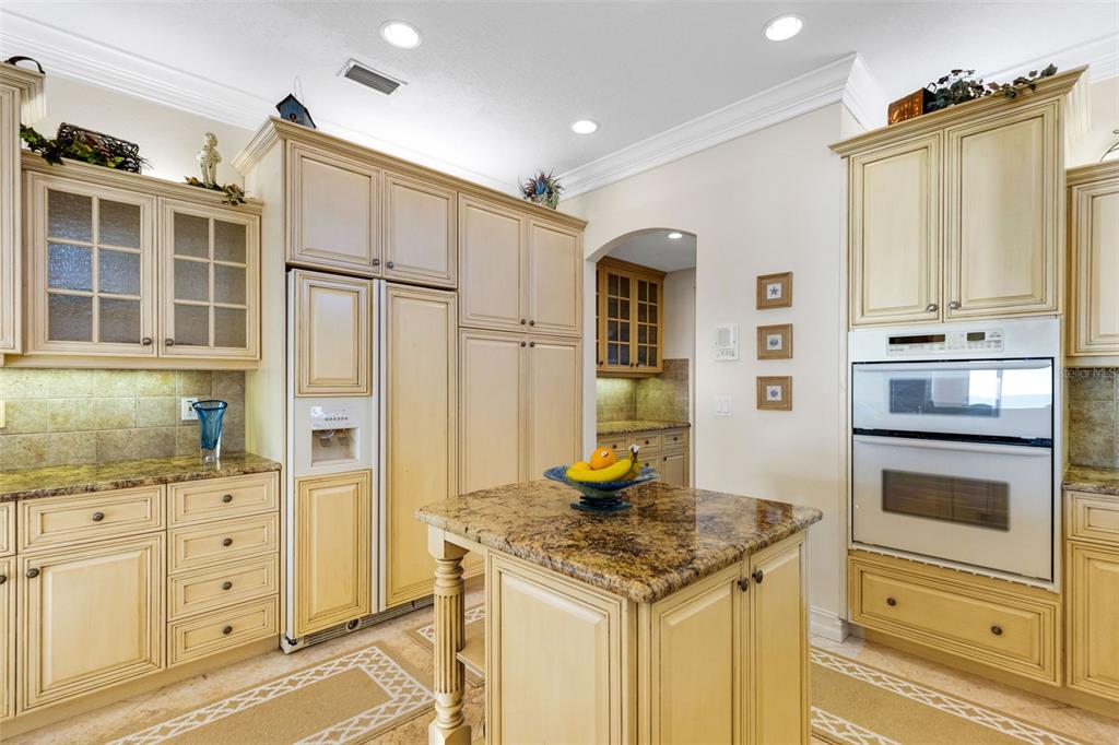 13423 Gulf Lane Madeira Beach, FL 33708 - Photo 17 of 71 a kitchen with granite countertop a stove and a refrigerator