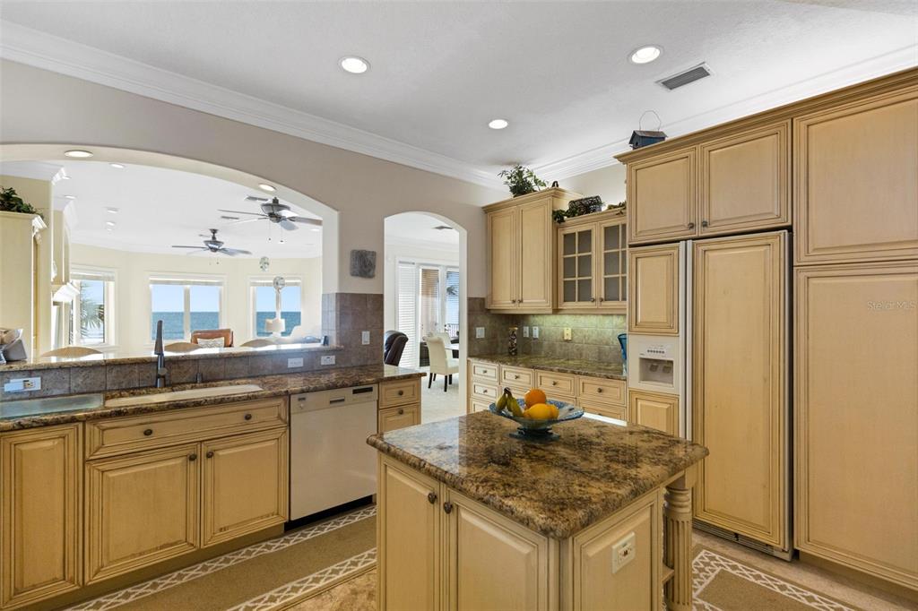 13423 Gulf Lane Madeira Beach, FL 33708 - Photo 18 of 71 a kitchen with stainless steel appliances granite countertop a sink and refrigerator
