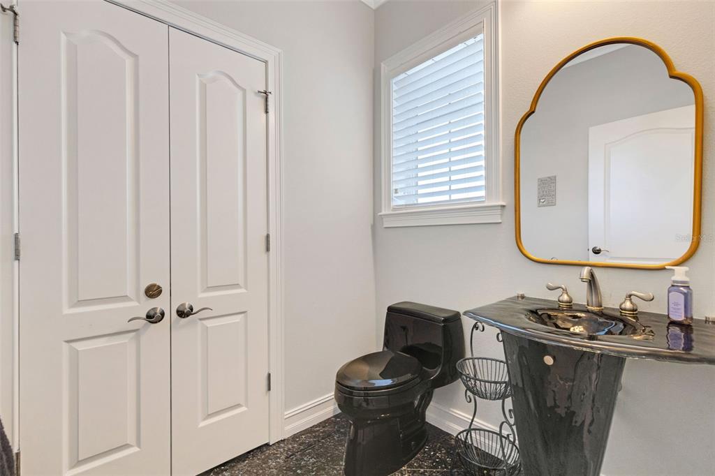 13423 Gulf Lane Madeira Beach, FL 33708 - Photo 19 of 71 a bathroom with a granite countertop toilet sink and mirror