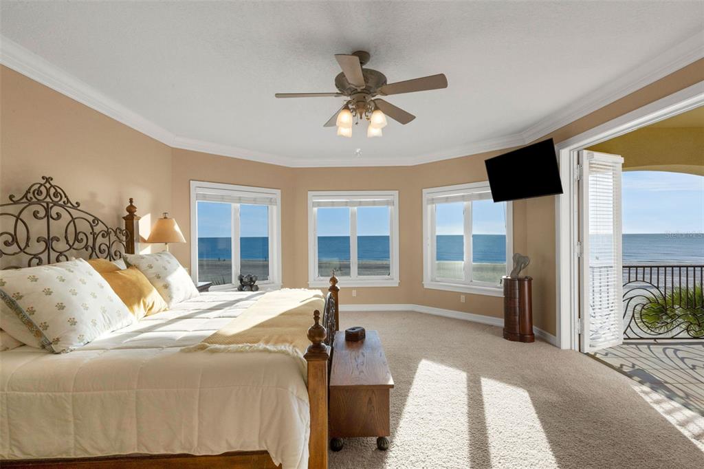 13423 Gulf Lane Madeira Beach, FL 33708 - Photo 29 of 71 a bedroom with a bed and glass door