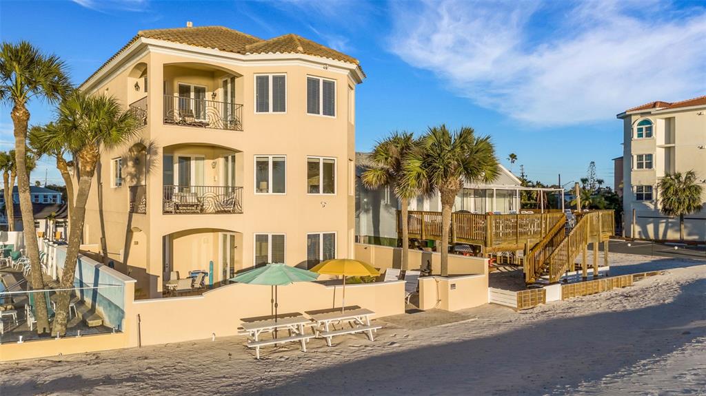 13423 Gulf Lane Madeira Beach, FL 33708 - Photo 3 of 71 a front view of a house with a garden
