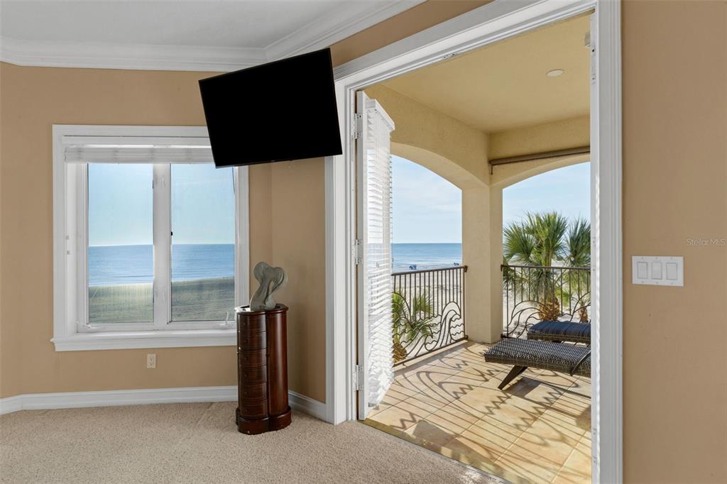 13423 Gulf Lane Madeira Beach, FL 33708 - Photo 34 of 71 a view of a hallway with two windows and a flat screen tv