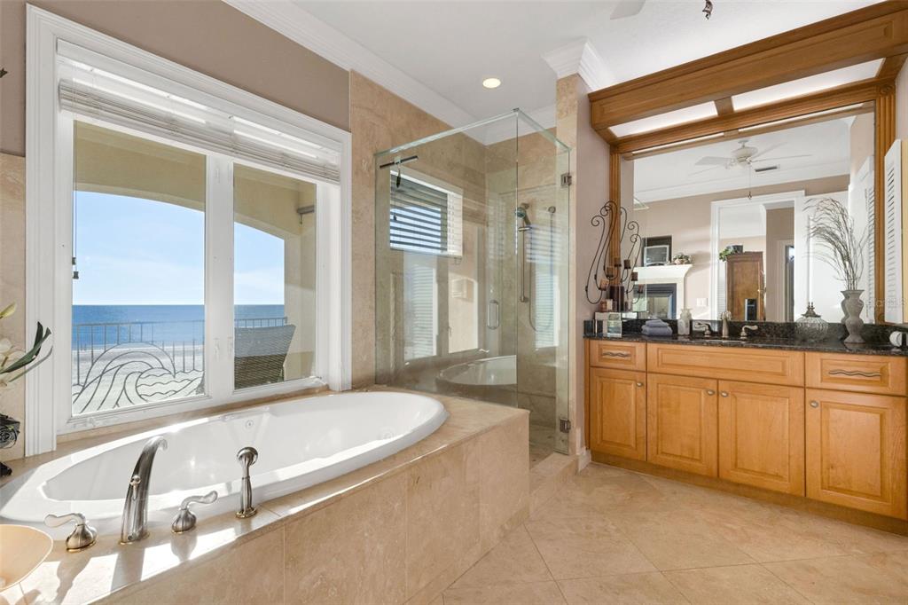 13423 Gulf Lane Madeira Beach, FL 33708 - Photo 43 of 71 a spacious bathroom with a tub and a large mirror