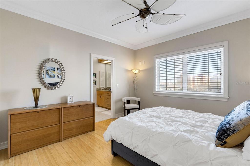 13423 Gulf Lane Madeira Beach, FL 33708 - Photo 48 of 71 a bedroom with a large bed and a chandelier