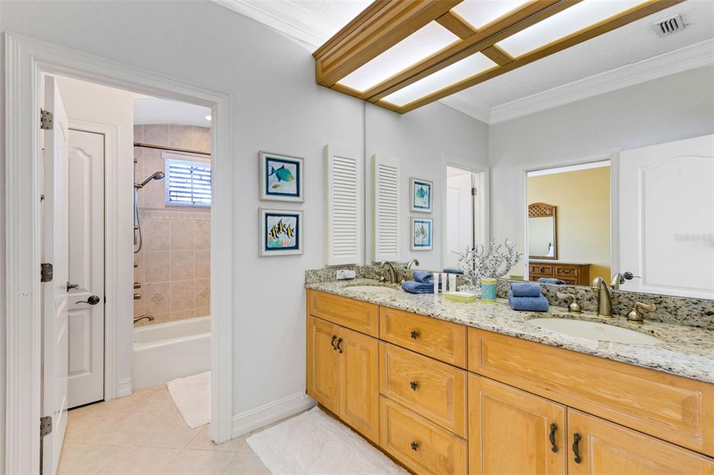13423 Gulf Lane Madeira Beach, FL 33708 - Photo 49 of 71 a bathroom with double sink and a mirror
